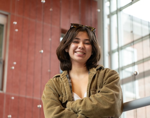 smiling on campus employer.  dark hair. 